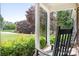 Front porch featuring white columns and relaxing rocking chair at 9000 Petunia Ct, Gastonia, NC 28056
