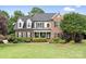 Charming brick two-story home features a lush, landscaped front yard and covered entryway at 9000 Petunia Ct, Gastonia, NC 28056