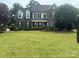 Charming two-story brick home with a well-manicured lawn and mature trees at 9000 Petunia Ct, Gastonia, NC 28056