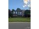 Charming two-story brick home with a well-manicured lawn and mature trees at 9000 Petunia Ct, Gastonia, NC 28056