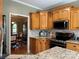 Cozy kitchen featuring granite countertops, stainless steel appliances, and wooden cabinetry at 9000 Petunia Ct, Gastonia, NC 28056