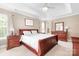 Spacious main bedroom with tray ceiling, ceiling fan, and elegant furniture at 9000 Petunia Ct, Gastonia, NC 28056