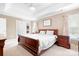 Main bedroom with a tray ceiling, neutral walls, and and nightstands at 9000 Petunia Ct, Gastonia, NC 28056
