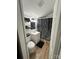 Bathroom features a floral shower curtain, modern vanity, and wood-look flooring at 918 8Th St # 5, Lancaster, SC 29720
