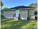 Tan vinyl siding home featuring a black roof, a white front door with steps and a green lawn at 918 8Th St # 5, Lancaster, SC 29720