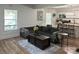 Open-concept living room with a large couch, kitchen bar and lots of natural light at 918 8Th St # 5, Lancaster, SC 29720