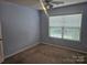 Bedroom with light blue walls, carpet flooring, ceiling fan, and a window at 9237 Bellegarde Dr, Charlotte, NC 28277