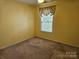 Cozy bedroom featuring neutral carpet, a ceiling fan, and a window offering natural light at 9237 Bellegarde Dr, Charlotte, NC 28277