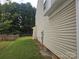 Side view of a home with light siding, green lawn, and a wooden fence at 9237 Bellegarde Dr, Charlotte, NC 28277