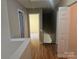 Hallway with hardwood floors leading to other rooms and a stairway at 9237 Bellegarde Dr, Charlotte, NC 28277