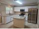Bright kitchen with white cabinetry, stainless steel appliances, island, and granite countertops at 9237 Bellegarde Dr, Charlotte, NC 28277