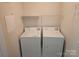 Convenient laundry room equipped with a washer and dryer, as well as shelving for storage at 9237 Bellegarde Dr, Charlotte, NC 28277
