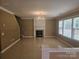 Open living room featuring a fireplace, large windows, and tile flooring at 9237 Bellegarde Dr, Charlotte, NC 28277