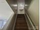 Staircase to the second floor with wood stairs and white railings at 9237 Bellegarde Dr, Charlotte, NC 28277