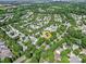 The aerial view shows the location of the home in a quiet neighborhood that is surrounded by trees at 9360 Meadowmont View Dr, Charlotte, NC 28269