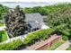 An aerial view highlights the fenced backyard and sunroom that are nestled between trees and lawn at 9360 Meadowmont View Dr, Charlotte, NC 28269
