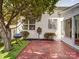 Enjoy grilling in the backyard with lush grass, a brick patio, a grill, and mature trees at 9360 Meadowmont View Dr, Charlotte, NC 28269