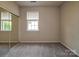 Bright bedroom with a neutral color palette and a mirrored sliding door closet at 9360 Meadowmont View Dr, Charlotte, NC 28269