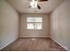 Spacious bedroom featuring neutral walls, carpet flooring and a ceiling fan with light fixture at 9360 Meadowmont View Dr, Charlotte, NC 28269