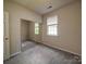 Cozy bedroom with a window for natural light and closet with mirrored sliding doors at 9360 Meadowmont View Dr, Charlotte, NC 28269