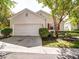 Home featuring a well-kept front yard with a two-car garage and complementary red shutters on the windows at 9360 Meadowmont View Dr, Charlotte, NC 28269