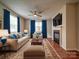 Cozy living room with elegant furnishings, plush seating, and a fireplace, creating a comfortable space at 9360 Meadowmont View Dr, Charlotte, NC 28269