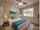 Comfortable primary bedroom with a bed, accent wall art and ample natural light at 9360 Meadowmont View Dr, Charlotte, NC 28269