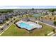 Aerial shot of the community pool, tennis courts, pool house, manicured landscaping, and lounge chairs at 1001 Linn Cv, Waxhaw, NC 28173