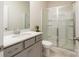 Clean bathroom with glass-enclosed shower, neutral countertops, and modern fixtures at 1001 Linn Cv, Waxhaw, NC 28173