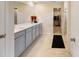 Double sink vanity and tiled floor in an elegant bathroom at 1001 Linn Cv, Waxhaw, NC 28173