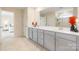 Bathroom featuring double sinks, light gray cabinets and decor at 1001 Linn Cv, Waxhaw, NC 28173