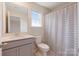 Neutral colored bathroom with sink, toilet and window at 1001 Linn Cv, Waxhaw, NC 28173