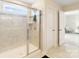 Shower with a glass door and tile surround in a bathroom with light colors at 1001 Linn Cv, Waxhaw, NC 28173