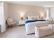 Well decorated bedroom with white furniture, tufted headboard, and bedside tables with lamps at 1001 Linn Cv, Waxhaw, NC 28173