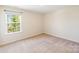 Inviting bedroom with natural light from the window, carpeted floors, and neutral wall paint at 1001 Linn Cv, Waxhaw, NC 28173