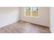 Bright bedroom featuring ample natural light from a double window and spacious wood flooring at 1001 Linn Cv, Waxhaw, NC 28173