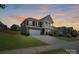 Stunning two-story home with a welcoming porch and a well-manicured lawn at 1001 Linn Cv, Waxhaw, NC 28173