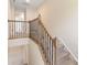 Upstairs hallway with wood and iron railing, carpeted stairs, and neutral walls at 1001 Linn Cv, Waxhaw, NC 28173