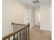 Carpeted hallway featuring neutral-toned walls and access to other rooms on the second floor at 1001 Linn Cv, Waxhaw, NC 28173