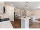 Bright eat-in kitchen featuring stainless steel appliances, quartz countertops, and an island with bar seating at 1001 Linn Cv, Waxhaw, NC 28173