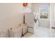 A bright laundry room featuring a washer and dryer, storage, and a window with a neighborhood view at 1001 Linn Cv, Waxhaw, NC 28173