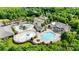 Aerial view of community pool featuring a large pool, kiddie area, splash pad, clubhouse, and ample seating at 1001 Linn Cv, Waxhaw, NC 28173