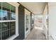 Covered porch with gray siding, white trim and wood flooring at 1001 Linn Cv, Waxhaw, NC 28173