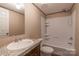 Bathroom featuring a combo tub and shower, toilet and sink with storage at 105 Peridot Dr, Statesville, NC 28625