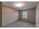 This bedroom offers neutral walls and carpet, plus a view from the window at 105 Peridot Dr, Statesville, NC 28625