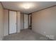 This bedroom offers neutral walls and carpet, plus two doors at 105 Peridot Dr, Statesville, NC 28625