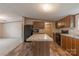 Spacious kitchen featuring an island, modern appliances, and wood-look flooring at 105 Peridot Dr, Statesville, NC 28625