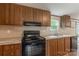 Wood-paneled kitchen offers a stainless steel sink and countertops, accompanied by matching appliances at 105 Peridot Dr, Statesville, NC 28625