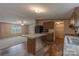 Well-lit kitchen boasts a kitchen island with sleek countertops, wood cabinets, and modern appliances at 105 Peridot Dr, Statesville, NC 28625