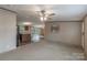 Carpeted open concept living room with kitchen and dining area access at 105 Peridot Dr, Statesville, NC 28625